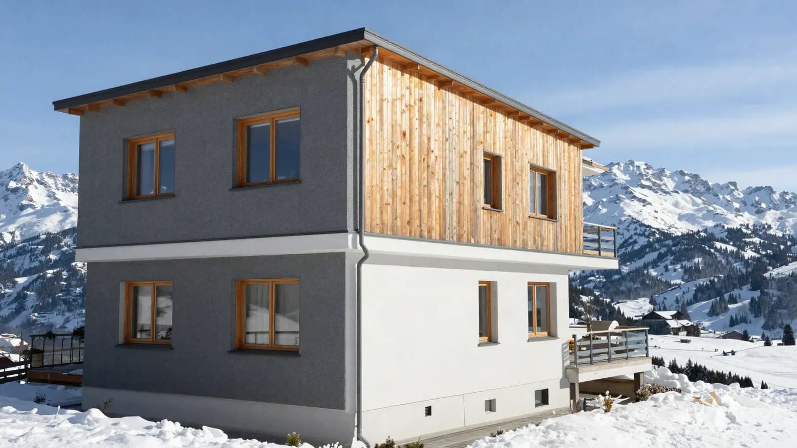 Edificio residenziale moderno con facciata in legno e finestre in legno davanti a montagne innevate